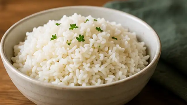 Improved cooked rice being served after excess moisture has been removed.