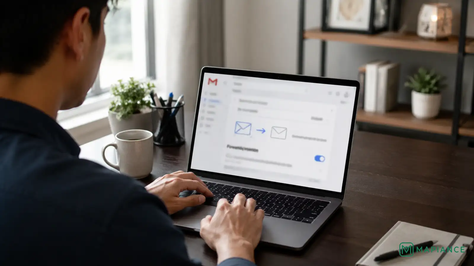 Person checking Gmail automatic forwarding settings on a laptop.