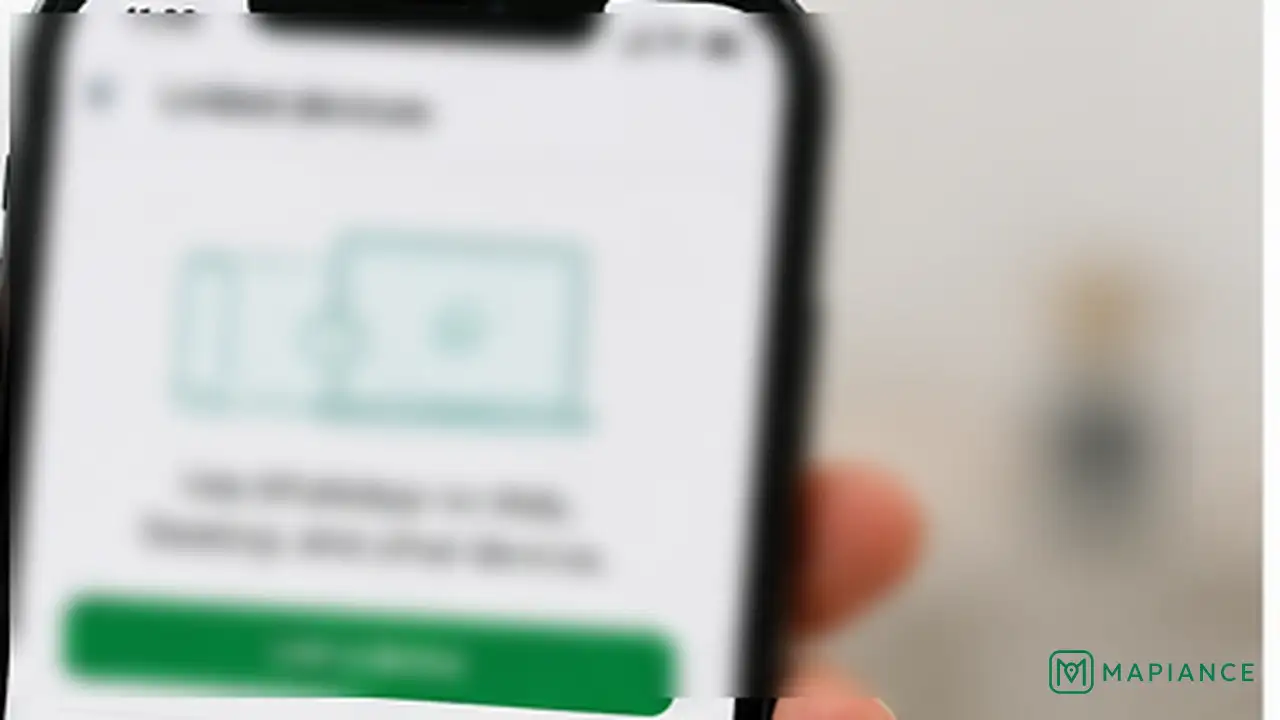 Person relinking WhatsApp on a laptop using the primary smartphone.
