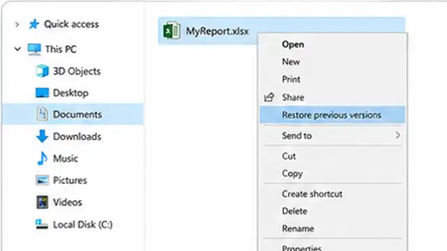 Person reviewing previous cloud versions of an Excel workbook before restoring one.