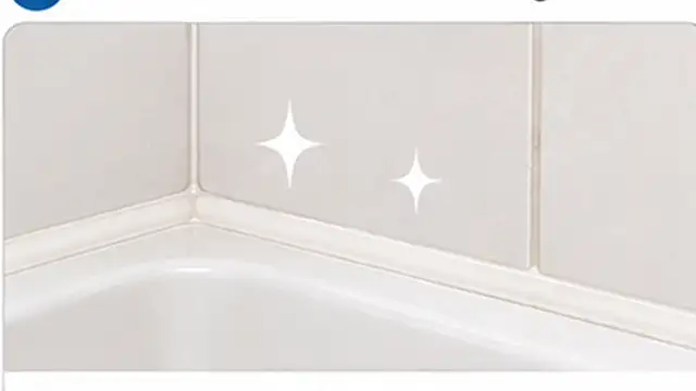 Person wiping water from clean shower caulk after a shower to help prevent mold from returning.